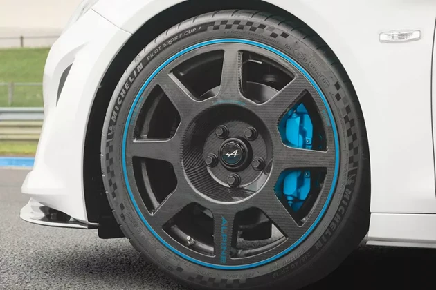Exposed carbon wheel with blue lining and brake callipers